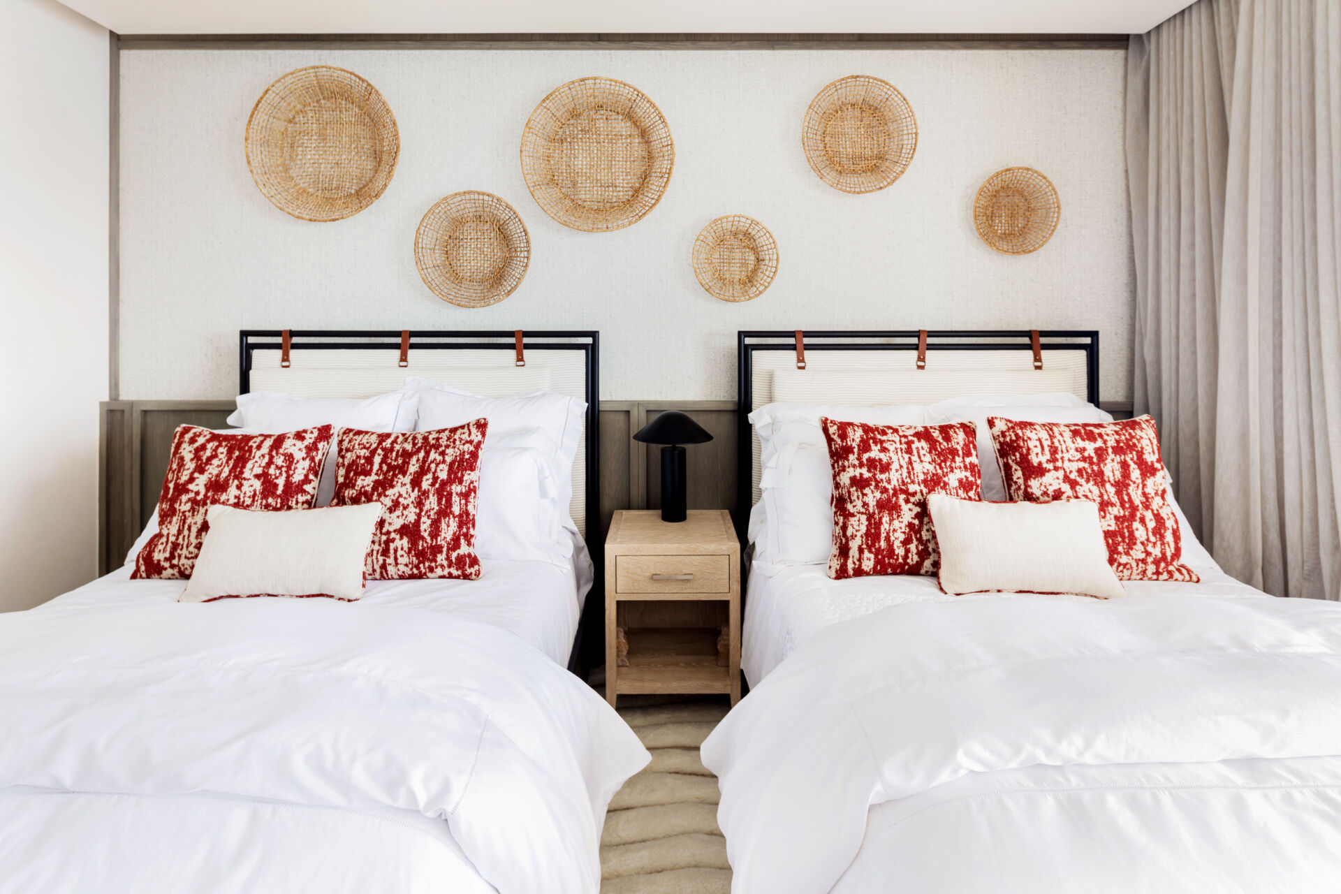 A modern bedroom opens to the outdoors and features natural materials for a calming aesthetic.